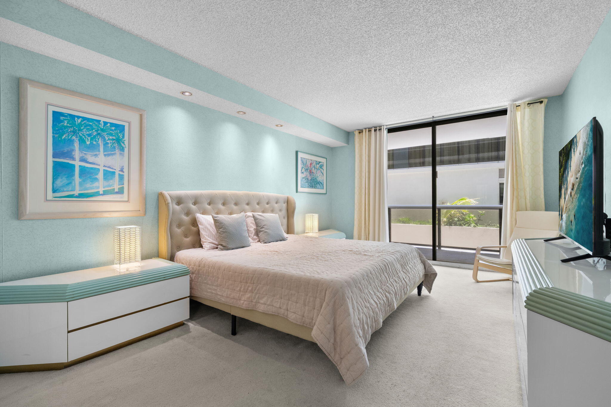 9455 Collins Avenue, Unit 305 Surfside, FL 33154 - Photo 11 of 58 a bedroom with a bed flat screen tv and a large window