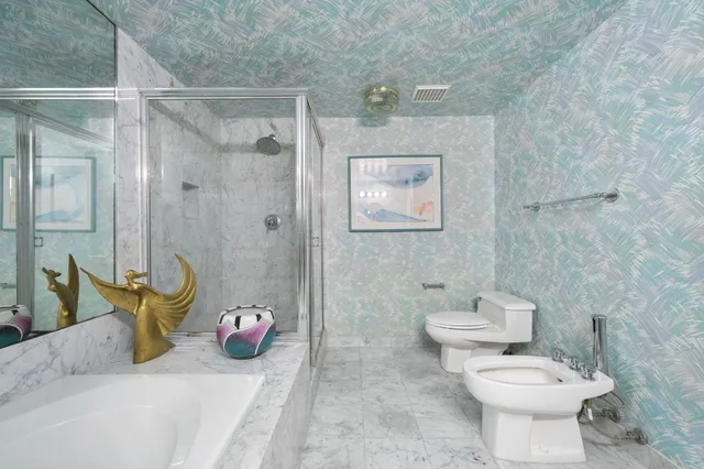 a bathroom with a toilet sink and shower