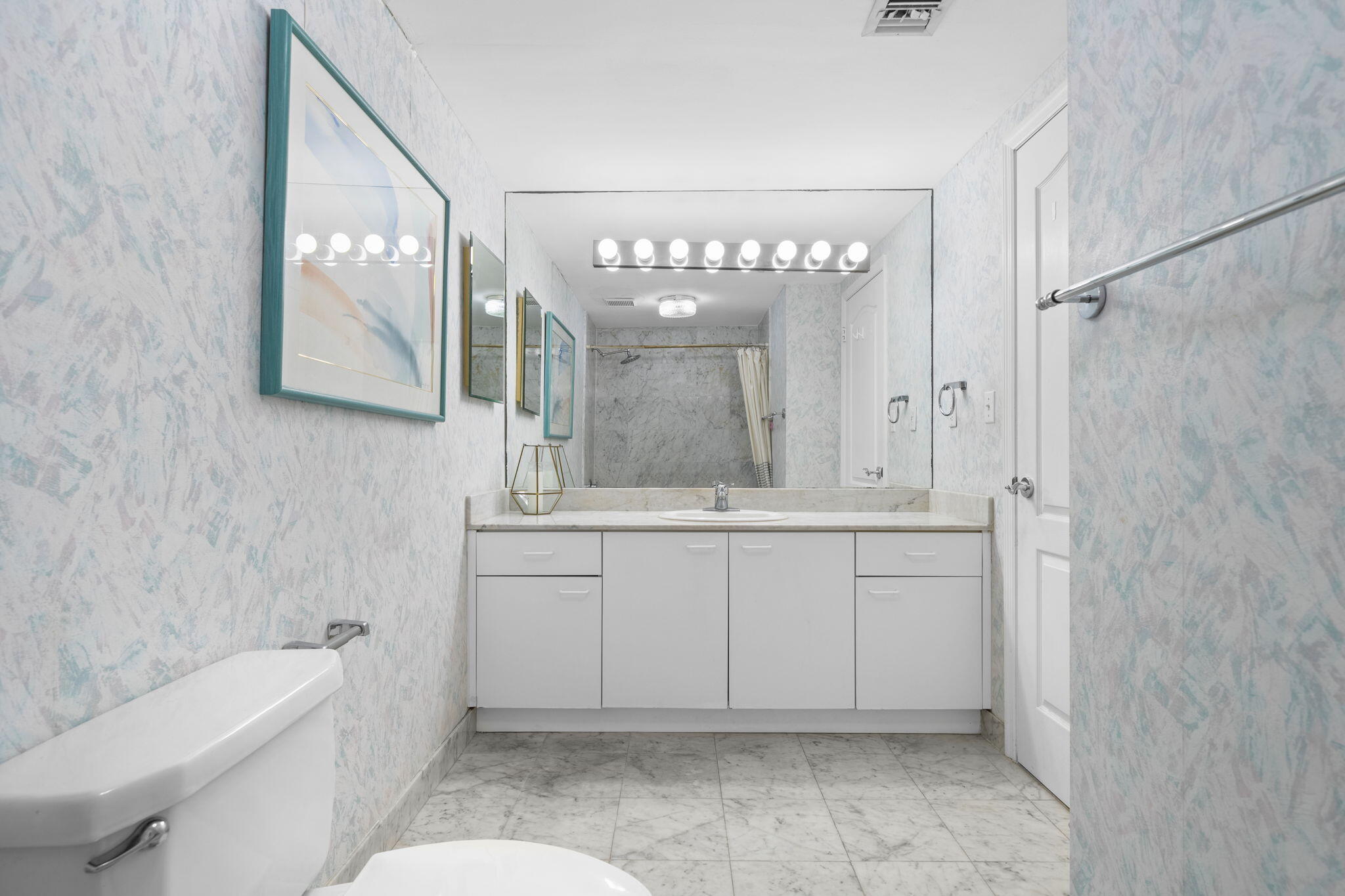 9455 Collins Avenue, Unit 305 Surfside, FL 33154 - Photo 23 of 58 a bathroom with a sink a toilet and mirror