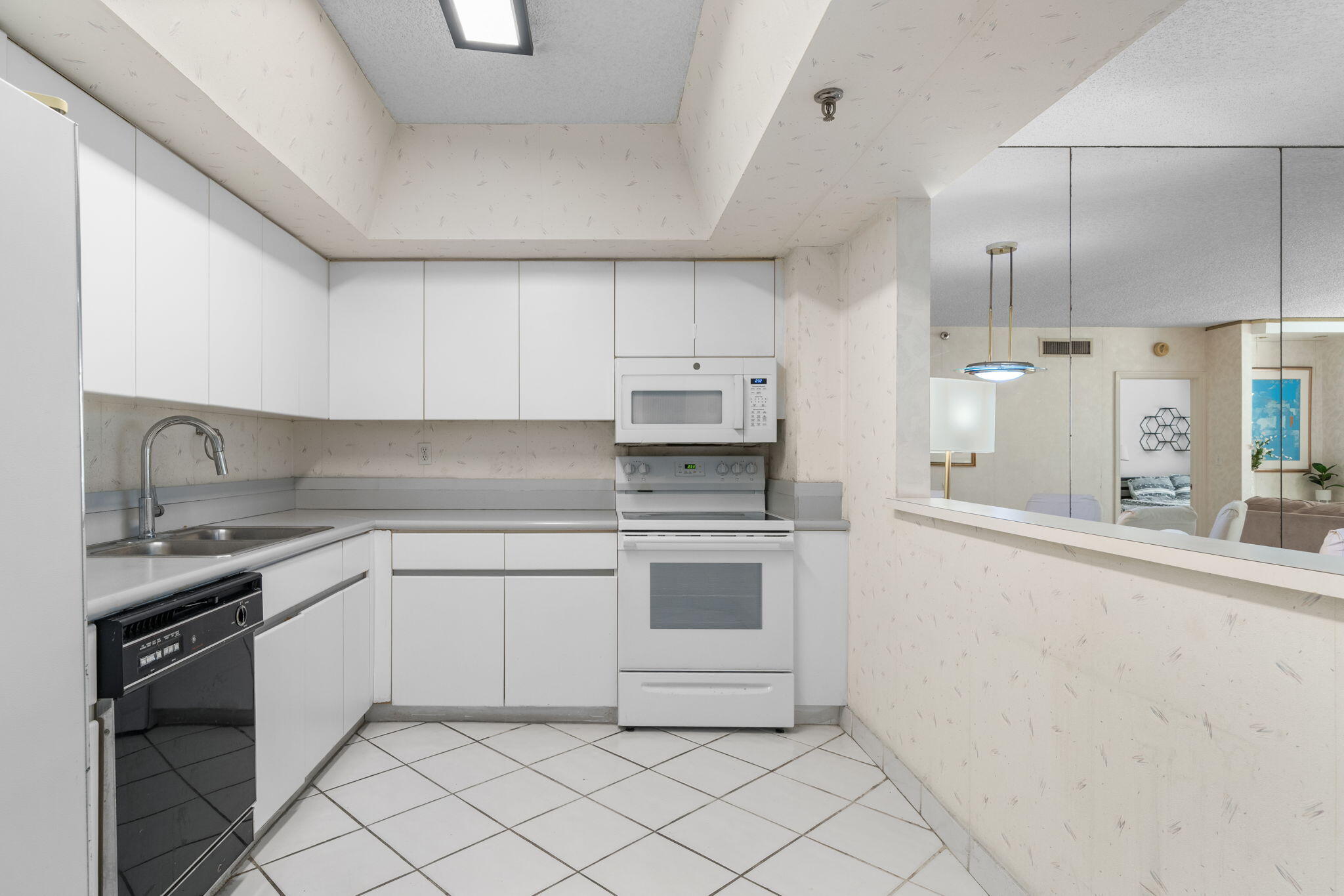 9455 Collins Avenue, Unit 305 Surfside, FL 33154 - Photo 7 of 58 a kitchen with stainless steel appliances granite countertop a sink and cabinets