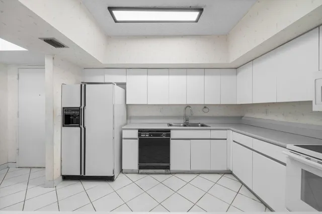 a kitchen with a stove sink and refrigerator