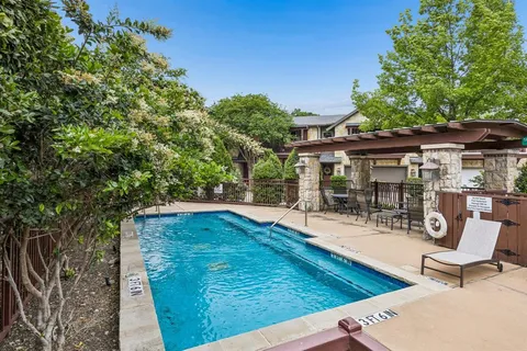 a view of a house with backyard porch and sitting area
