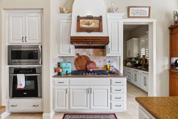 a kitchen with stainless steel appliances granite countertop a stove and a microwave