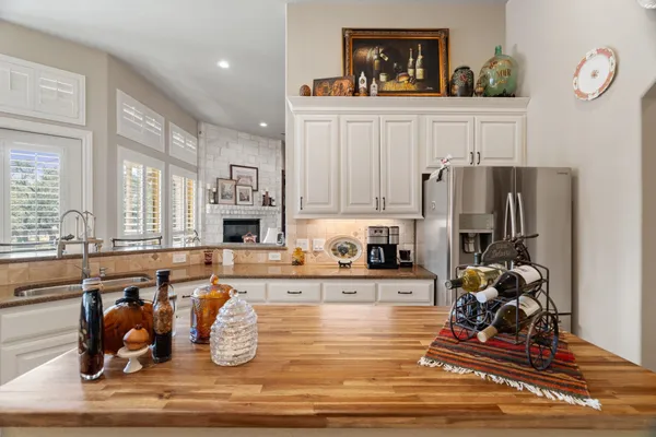 a kitchen with stainless steel appliances granite countertop a refrigerator and a stove top oven