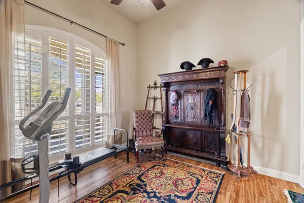 a living room with furniture a rug and a floor to ceiling window