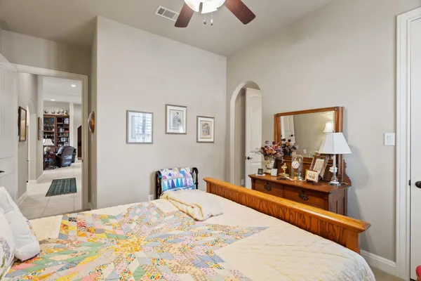 a bedroom with a bed and a dresser