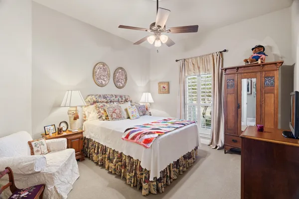 a bedroom with bed and a chandelier