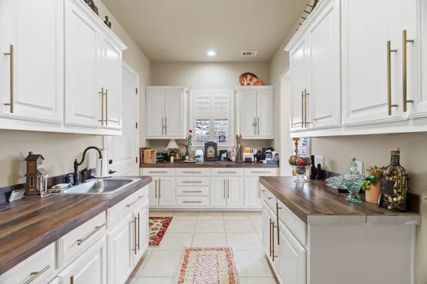 a kitchen with stainless steel appliances granite countertop a sink a stove and cabinets