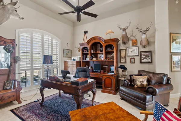 a living room with furniture a rug and a window