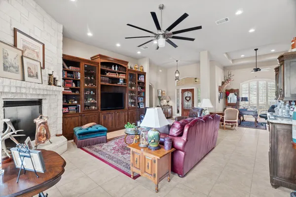 a living room with fireplace furniture and a wooden floor