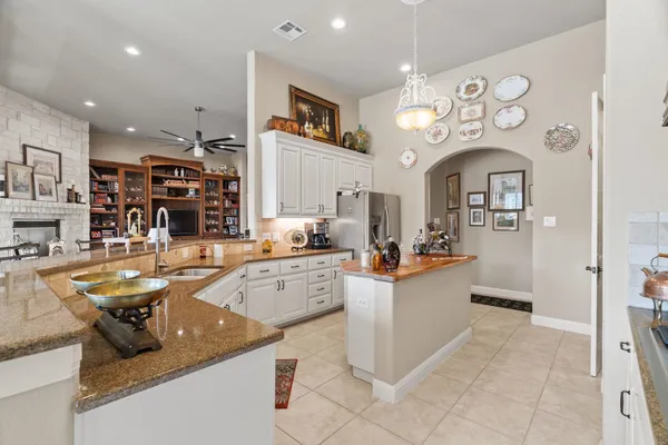 a large kitchen with lots of counter space and stainless steel appliances