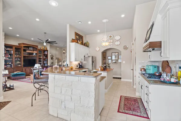 a living room with lots of furniture and kitchen view