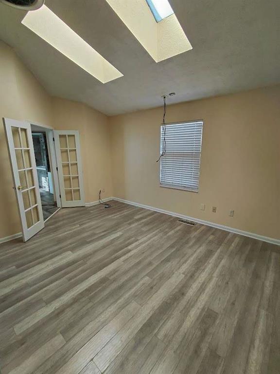 2291 Wilkins Court Decatur, GA 30035 - Photo 11 of 19 an empty room with wooden floor and windows