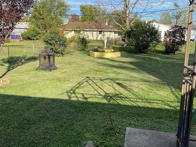 1940 South Richmond Road Decatur, IL 62521 - Photo 3 of 6 a view of a swimming pool with a garden and trees