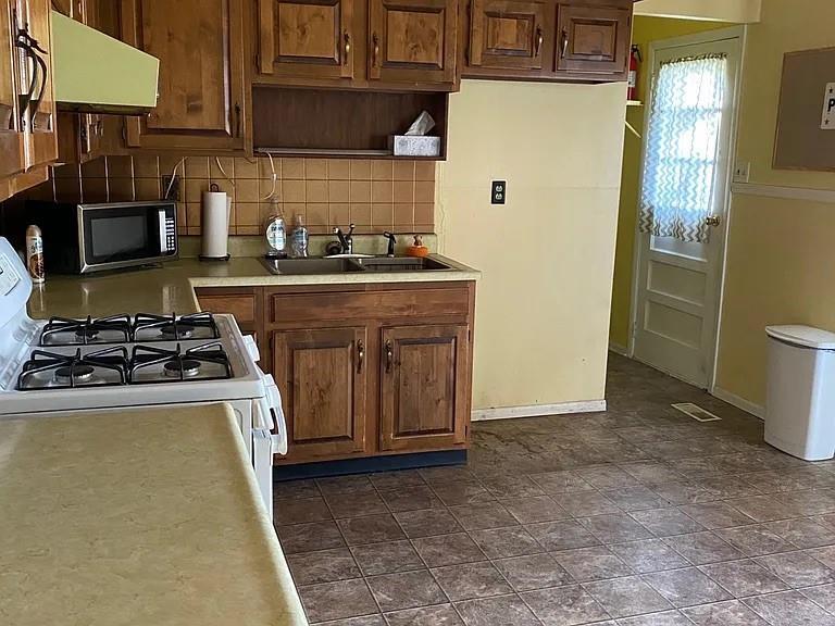 1940 South Richmond Road Decatur, IL 62521 - Photo 5 of 6 a kitchen with stainless steel appliances granite countertop a refrigerator and a stove