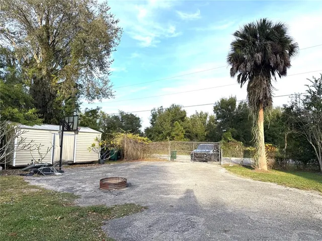 a view of a patio with table and chairs and potted plants