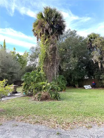 a view of a house with a garden and pathway