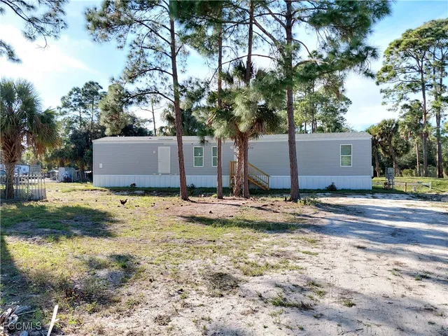 a view of a house with snow on the road