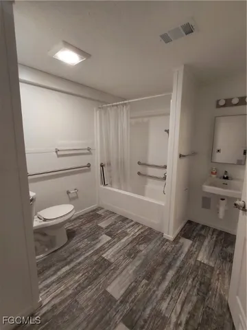 a bathroom with a toilet a sink and a bathtub