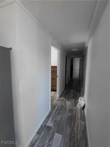 a view of hallway with wooden floor
