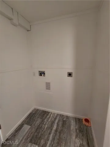 a view of a small space with wooden floor and window