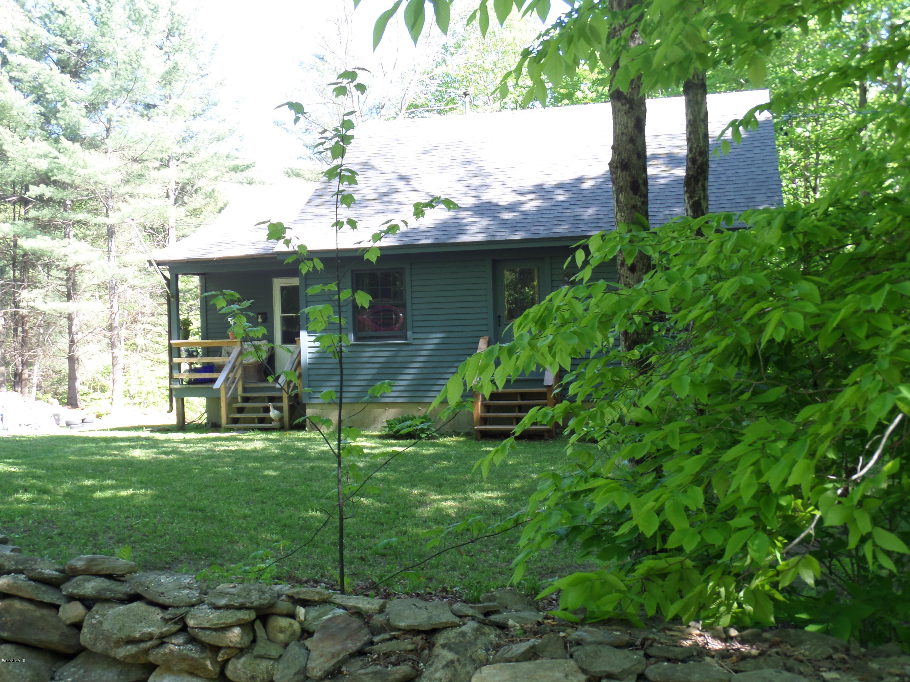 800 Sportsman Road Stamford, VT 05352 - Photo 2 of 26 a backyard of a house with table and chairs