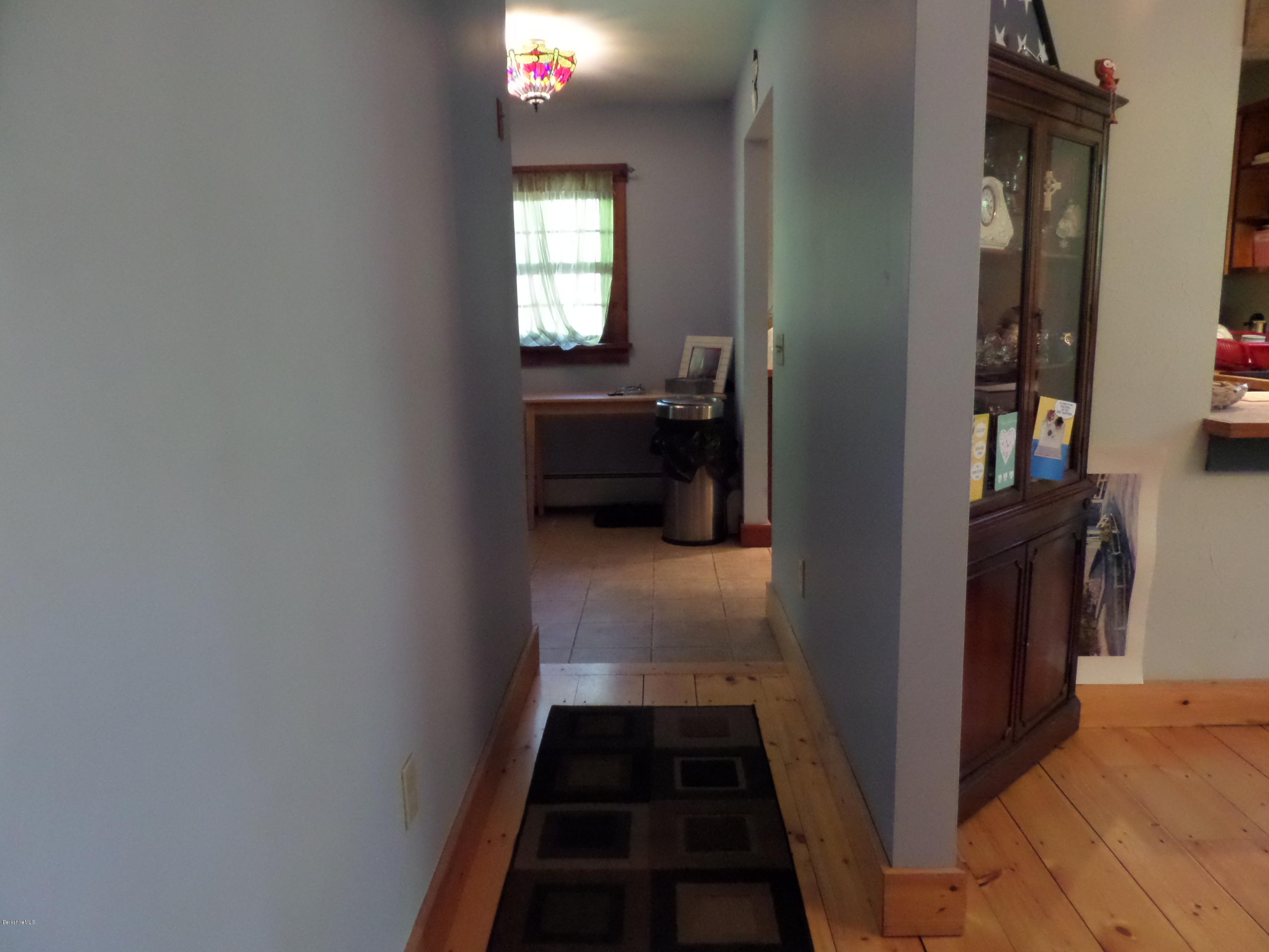 800 Sportsman Road Stamford, VT 05352 - Photo 14 of 26 a view of a hallway and a livingroom with furniture
