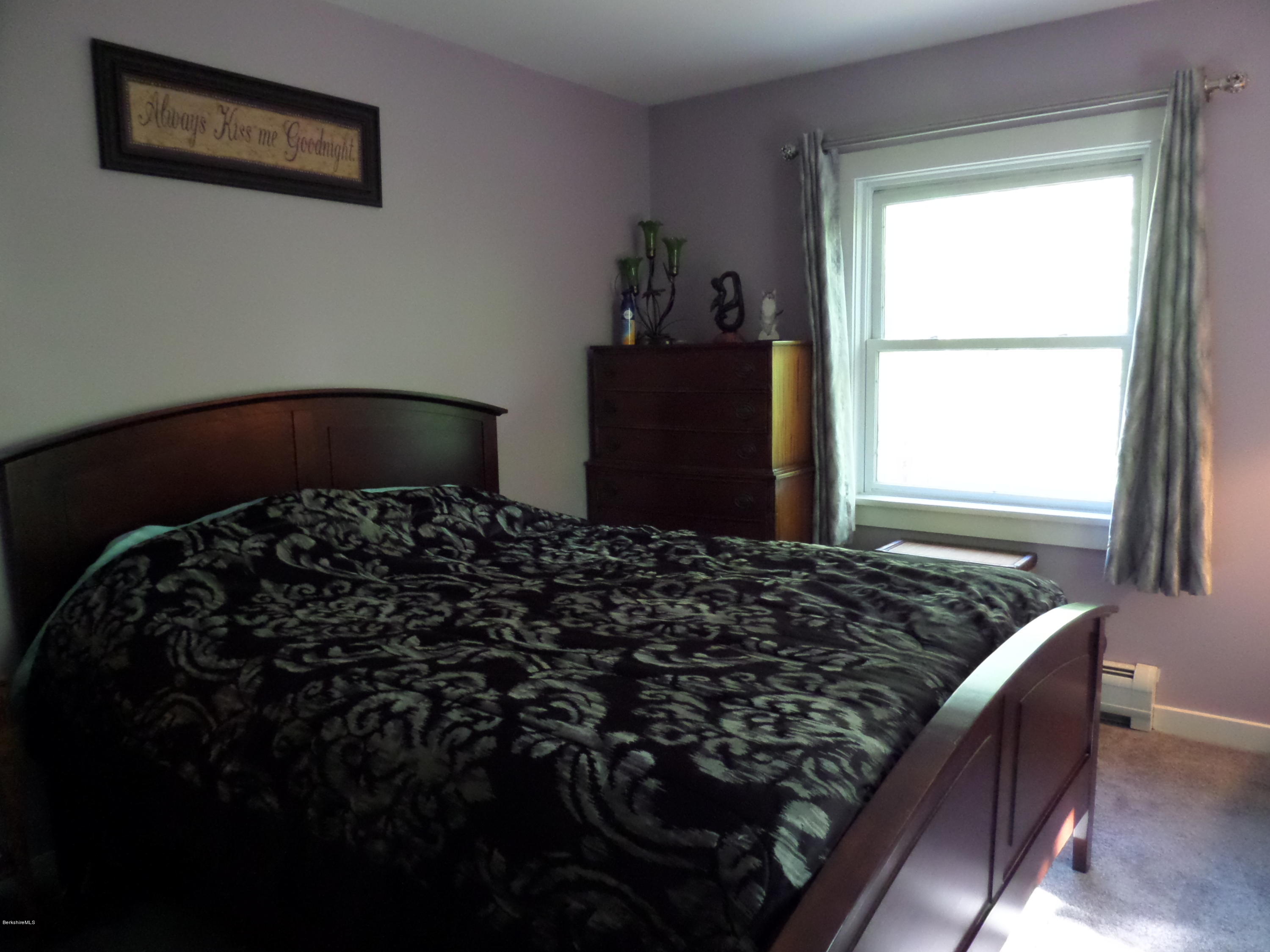 800 Sportsman Road Stamford, VT 05352 - Photo 18 of 26 a bed sitting in a bedroom next to a window
