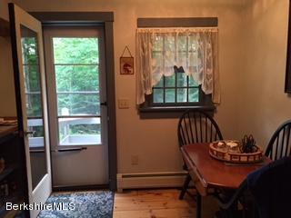 800 Sportsman Road Stamford, VT 05352 - Photo 22 of 26 a view of a porch with furniture and a window