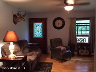 800 Sportsman Road Stamford, VT 05352 - Photo 25 of 26 a living room with furniture a window and a lamp