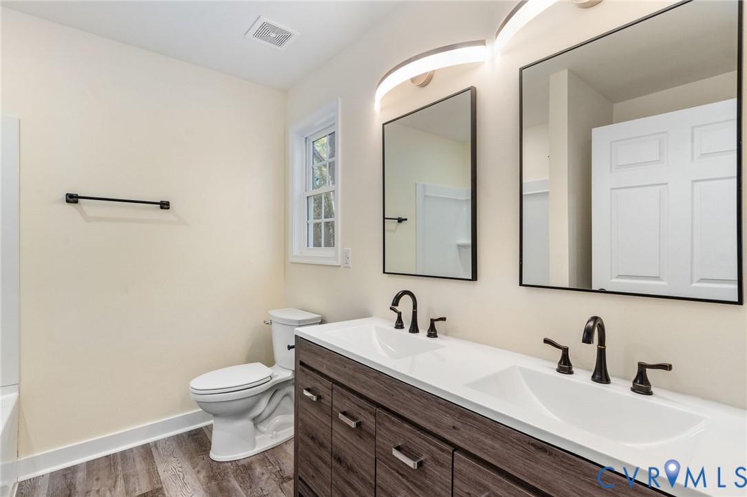 11206 South Crater Road Petersburg, VA 23805 - Photo 13 of 19 a bathroom with a sink a toilet and mirror