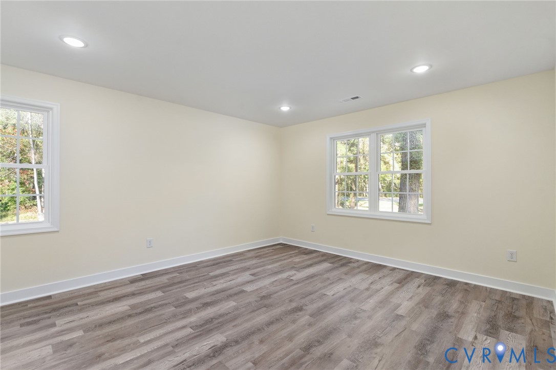11206 South Crater Road Petersburg, VA 23805 - Photo 15 of 19 an empty room with wooden floor and windows