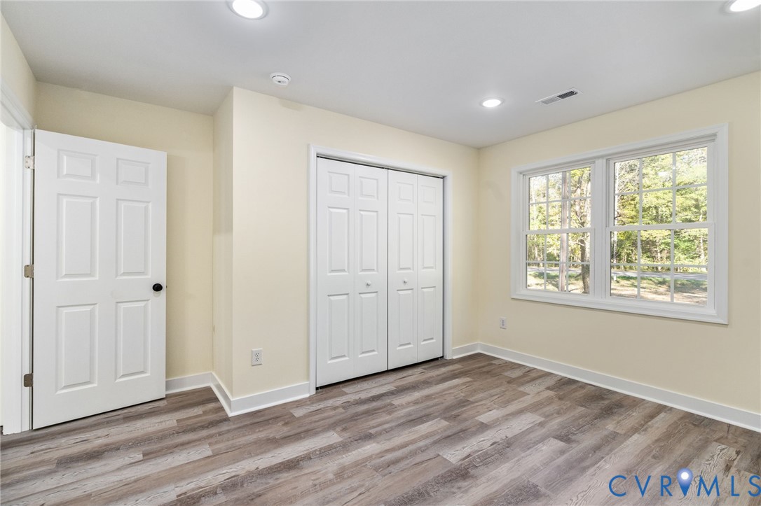 11206 South Crater Road Petersburg, VA 23805 - Photo 17 of 19 a view of an empty room with wooden floor and a window