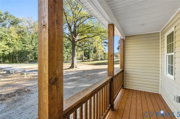 a view of a porch with wooden floor and fence