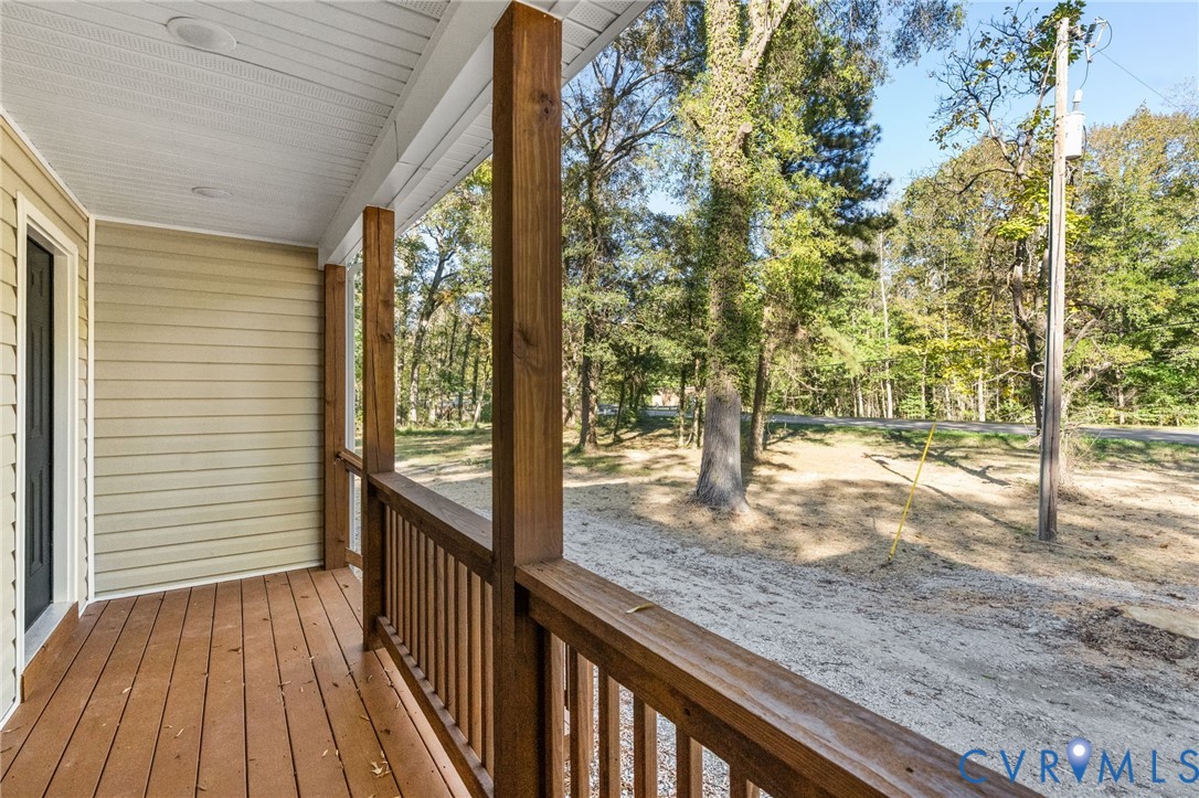 11206 South Crater Road Petersburg, VA 23805 - Photo 6 of 19 a view of a porch with wooden floor and fence