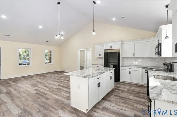 a kitchen with a sink stove and cabinets