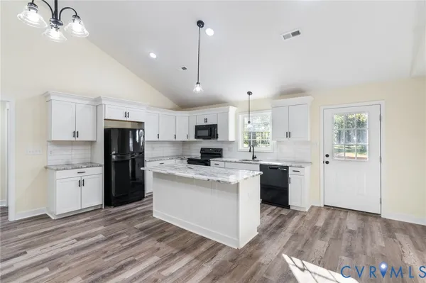 a large kitchen with cabinets and stainless steel appliances
