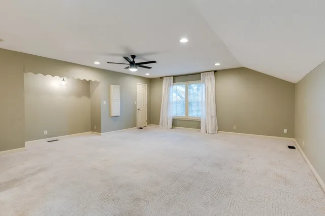 a view of an empty room with a ceiling fan