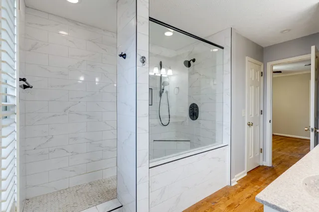 a bathroom with a shower and a sink