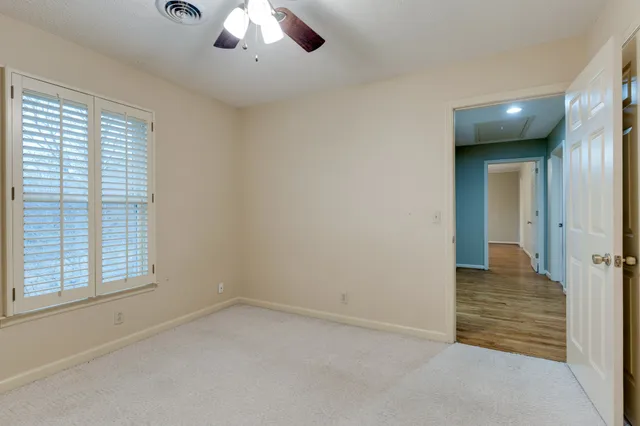 an empty room with windows and closet