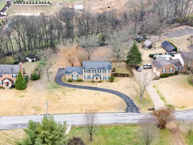 an aerial view of a city with lots of residential buildings ocean and mountain view in back