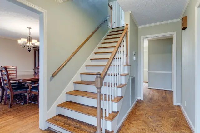 a view of entryway and hall with wooden floor