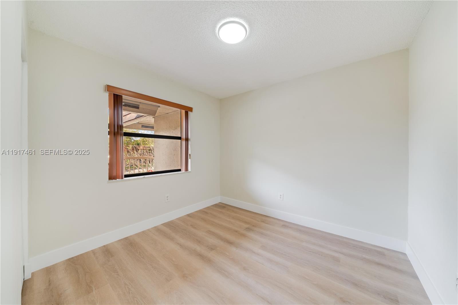 14847 Southwest 104th Street, Unit 10203 Miami, FL 33196 - Photo 16 of 22 an empty room with a window