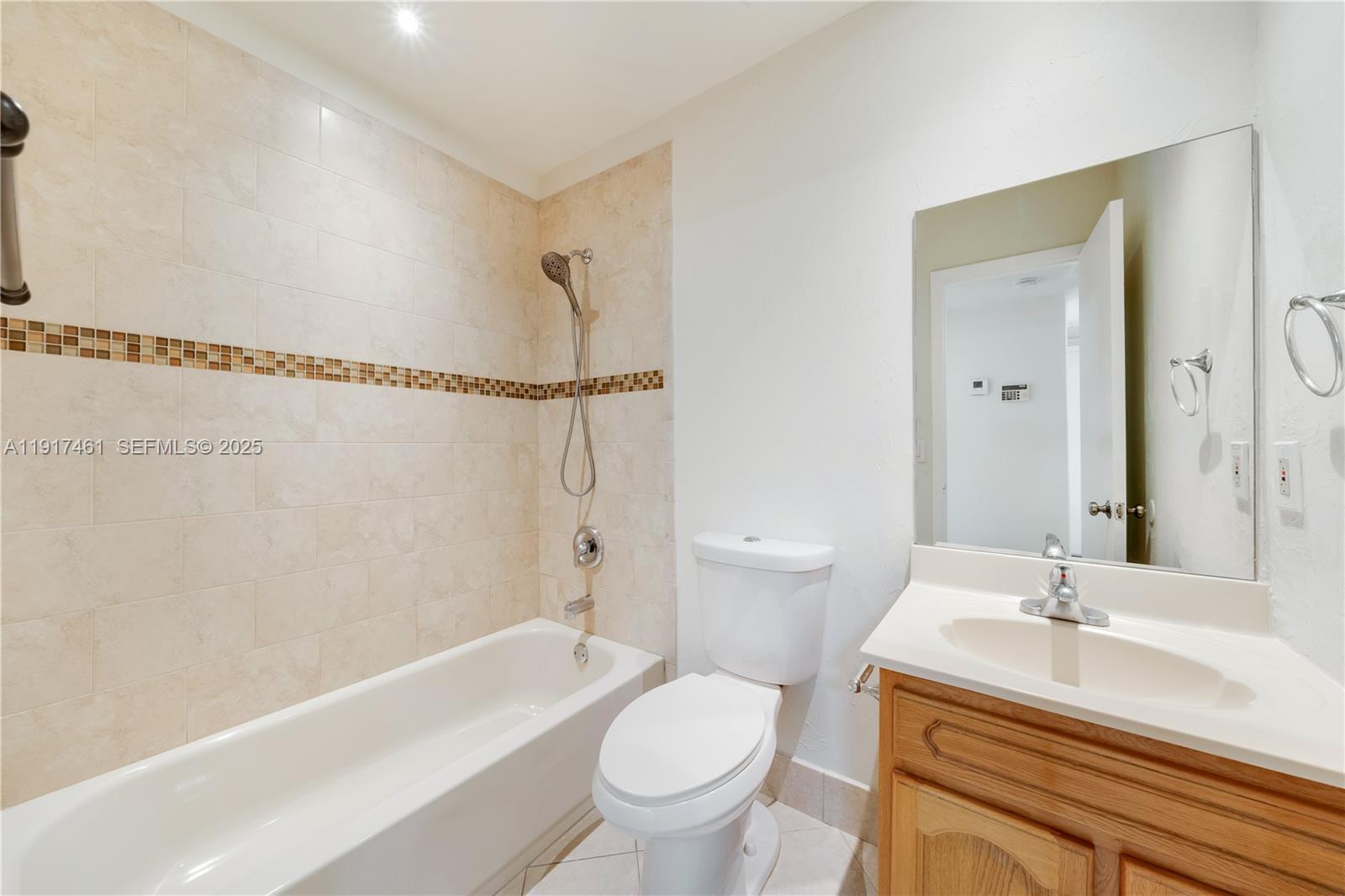 14847 Southwest 104th Street, Unit 10203 Miami, FL 33196 - Photo 17 of 22 a bathroom with a sink a toilet and a bathtub