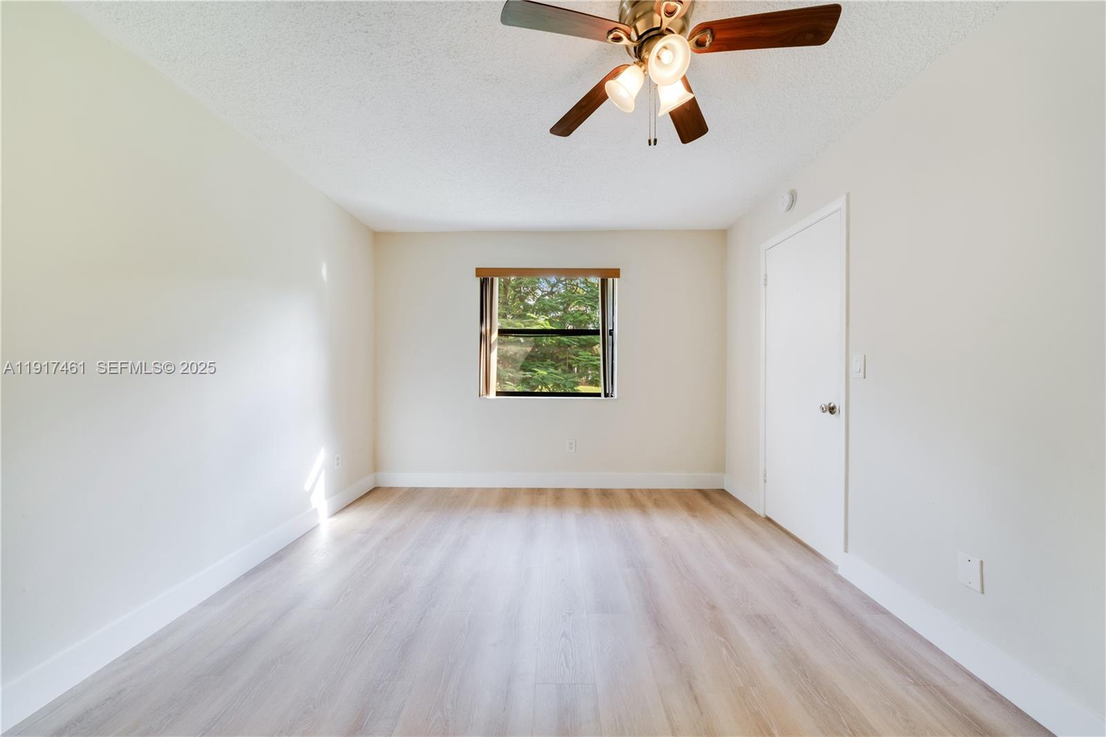 14847 Southwest 104th Street, Unit 10203 Miami, FL 33196 - Photo 6 of 22 an empty room with windows and fan