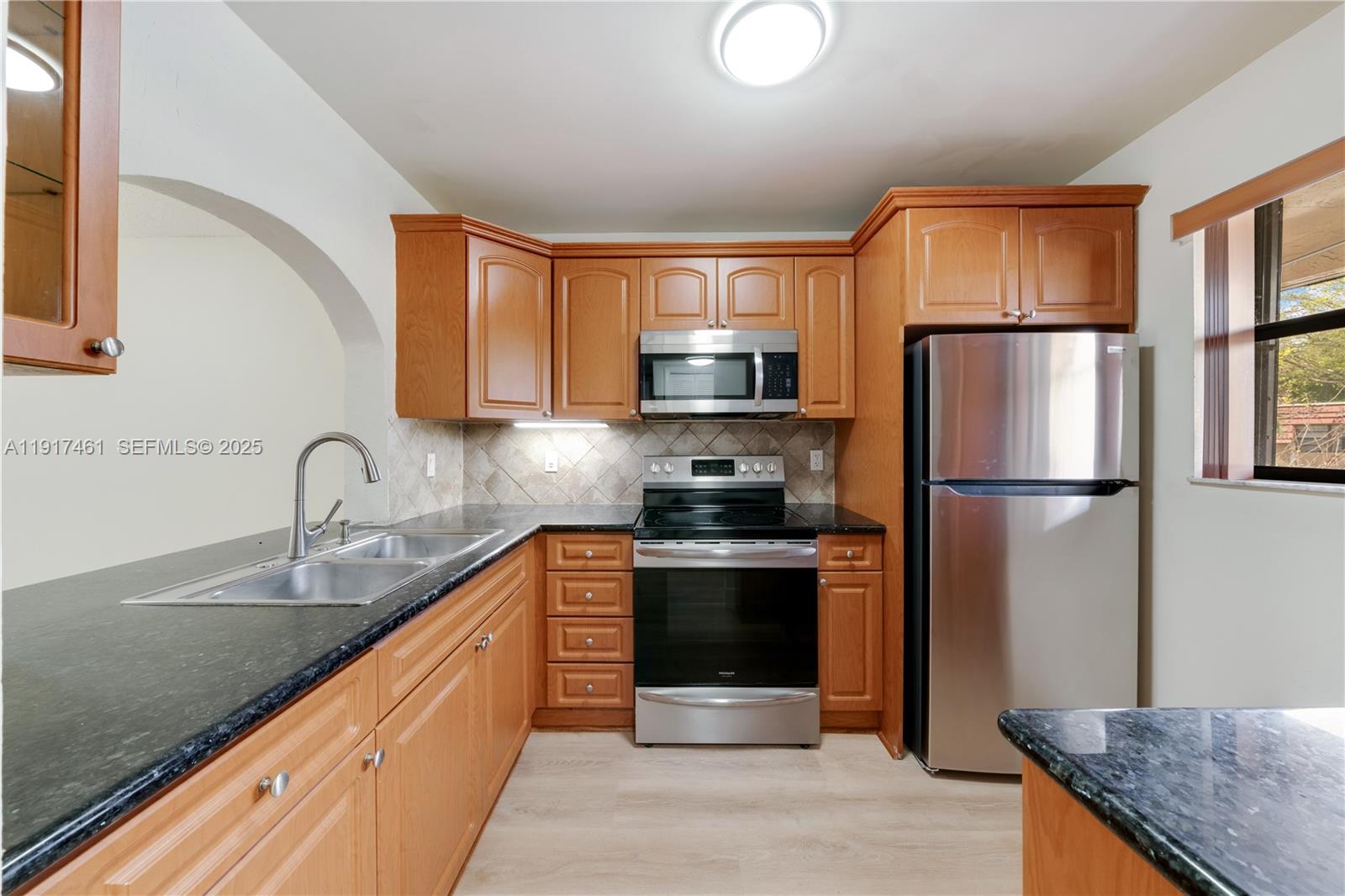 14847 Southwest 104th Street, Unit 10203 Miami, FL 33196 - Photo 9 of 22 a kitchen with stainless steel appliances granite countertop a refrigerator sink and stove