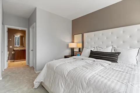 a bedroom with a bed and painting on the wall