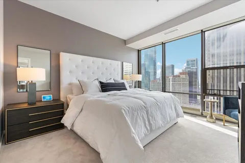 a bedroom with a bed and large mirror