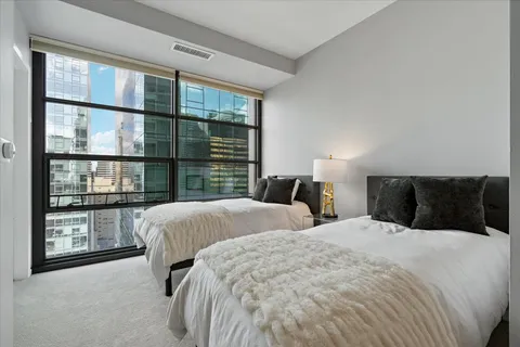 a bedroom with a large bed and a large window