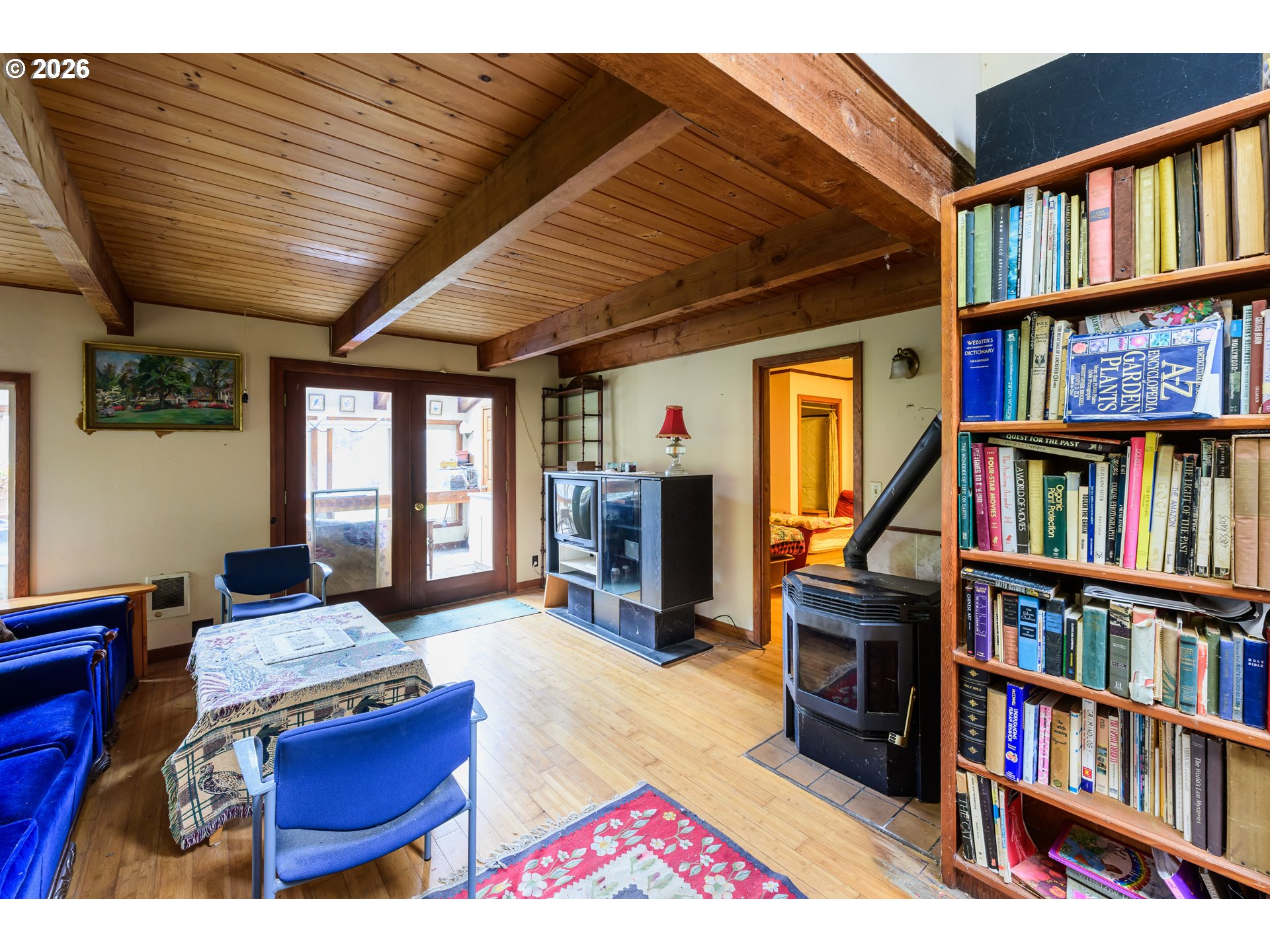 1377 Moonshine Park Road Logsden, OR 97357 - Photo 12 of 40 a living room with hard wood flooring and a book shelf